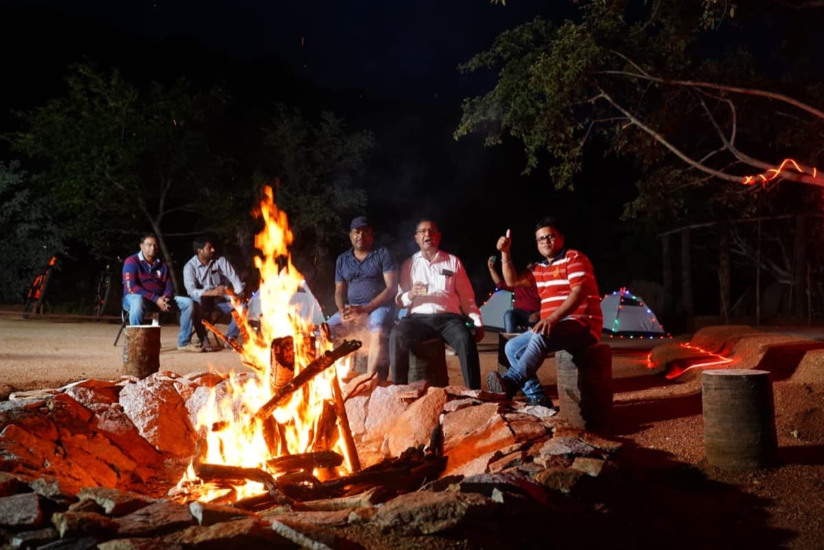 Campers gathered around a campfire